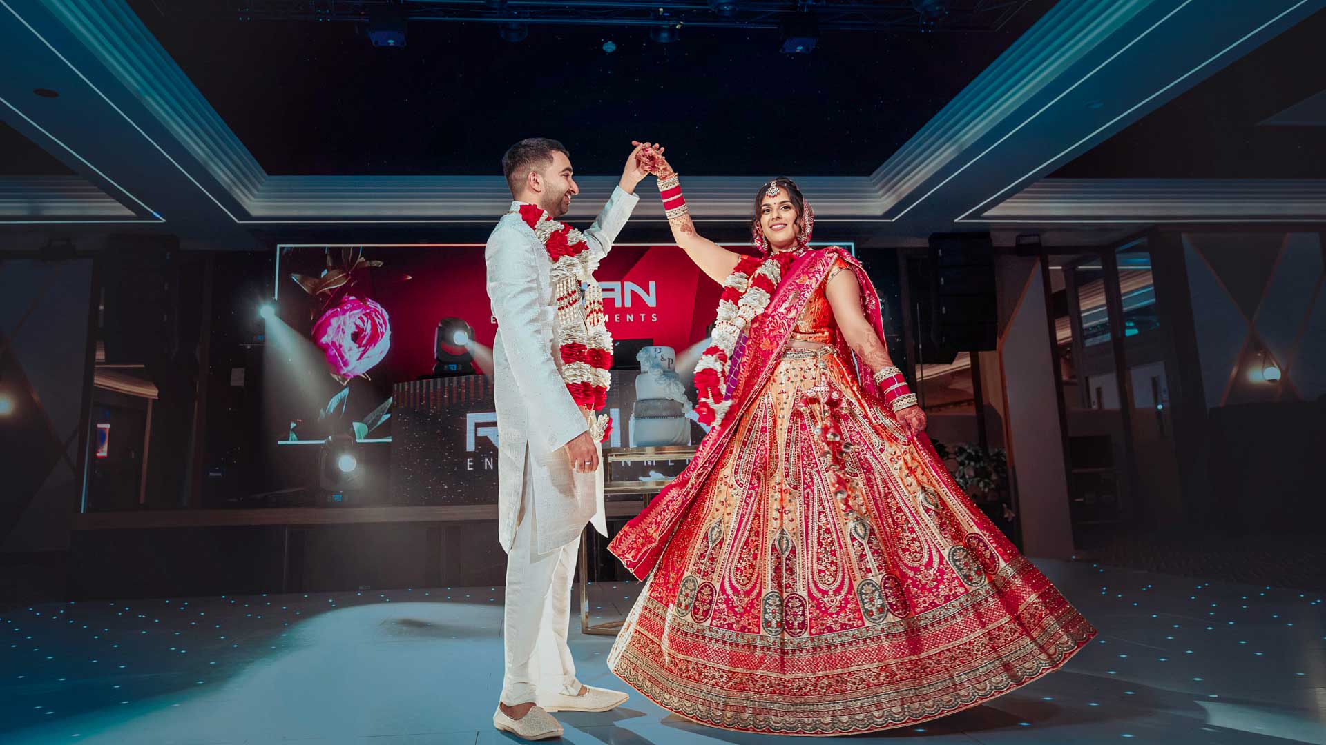 Beautiful Indian couple on the dance floor on their wedding day at the Rose Garden Hall