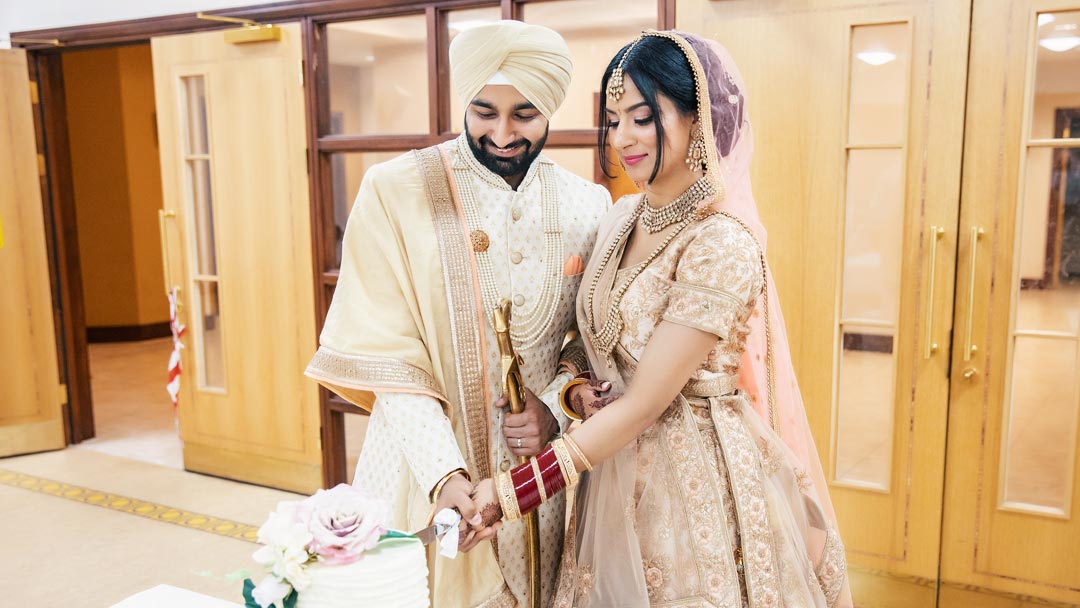 Sisters hold a groom's palla before the barrat in Coventry.