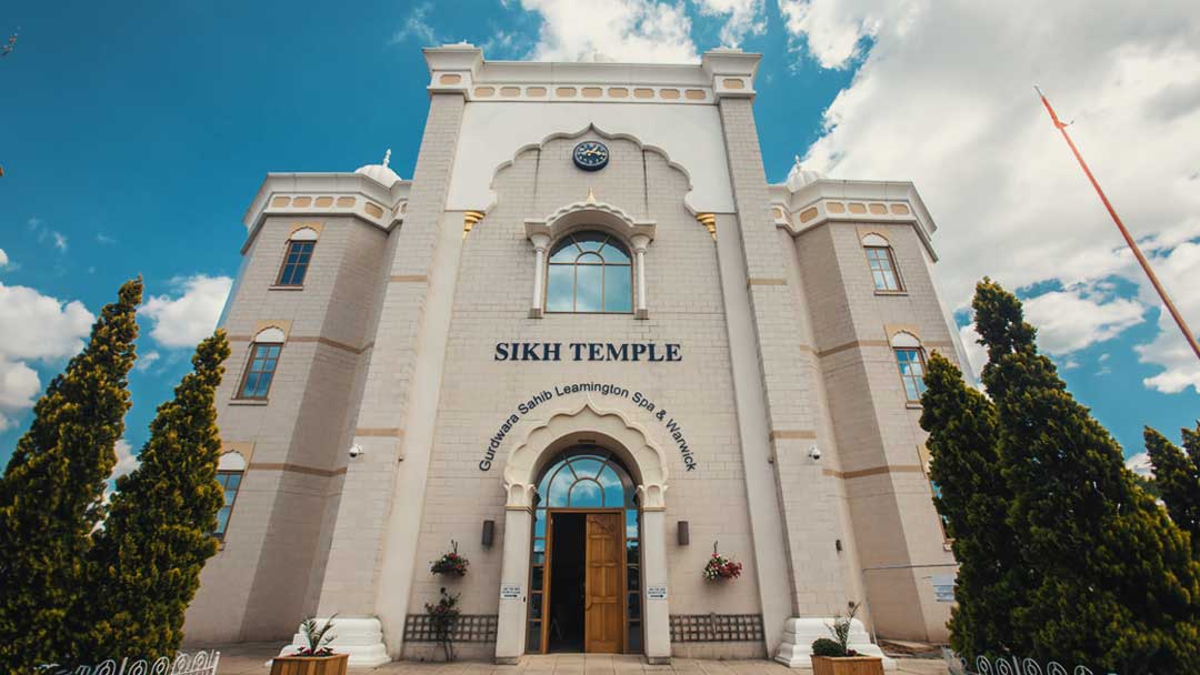 A front view of Leamington Gurdwara shows a written Sikh temple. 