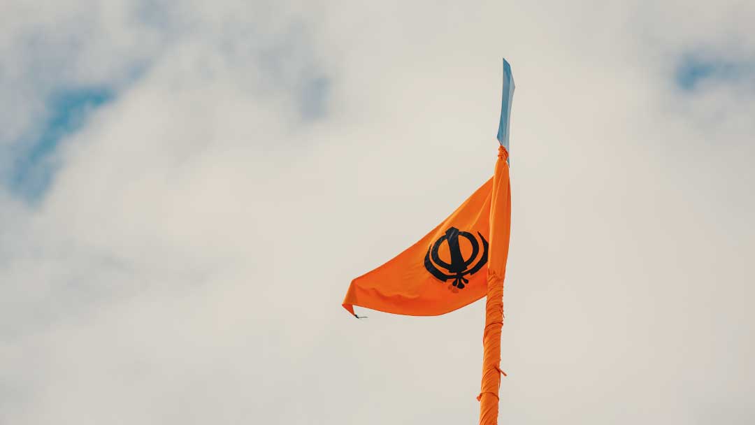 Orange Nishan Sahib flying in the sky at Gurdwara Sahib Leamington & Warwick. 