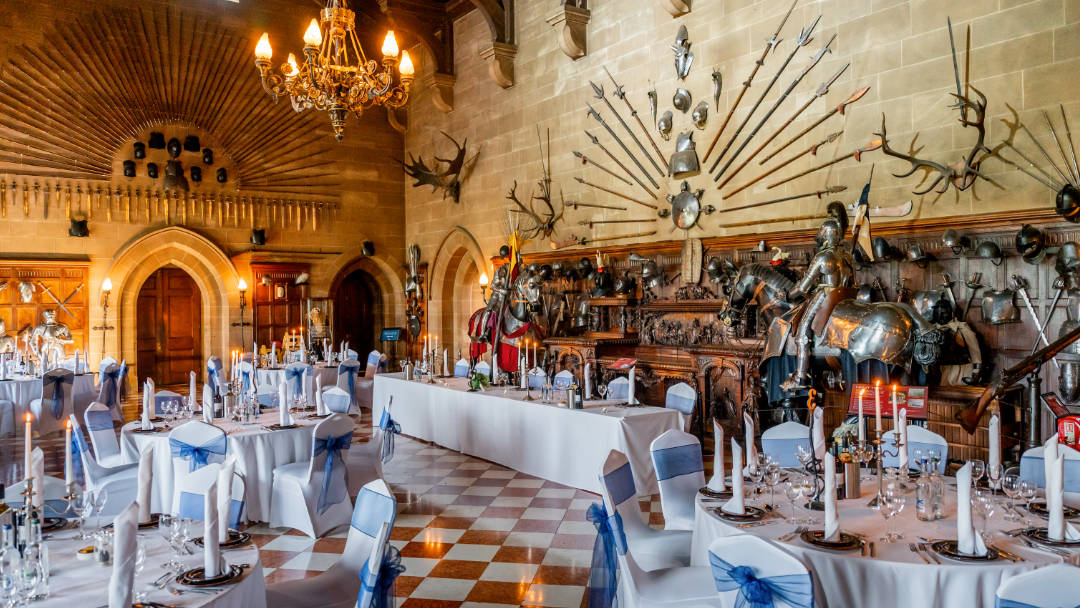 The Great Hall photo at Warwick Castle features rows of decorated chairs.