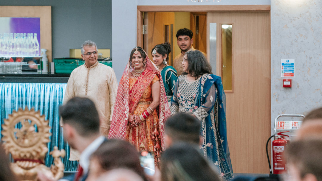 Sisters hold a groom's palla before the barrat in Coventry.