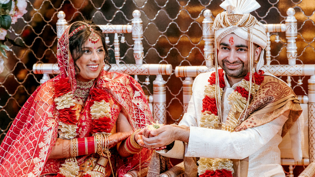 Sisters hold a groom's palla before the barrat in Coventry.