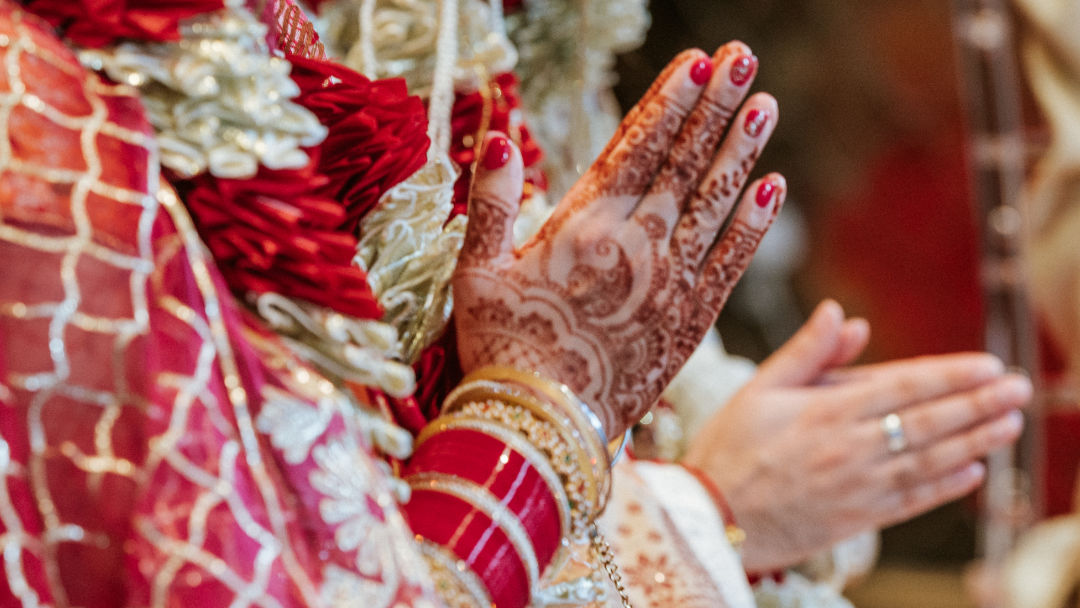 Sisters hold a groom's palla before the barrat in Coventry.