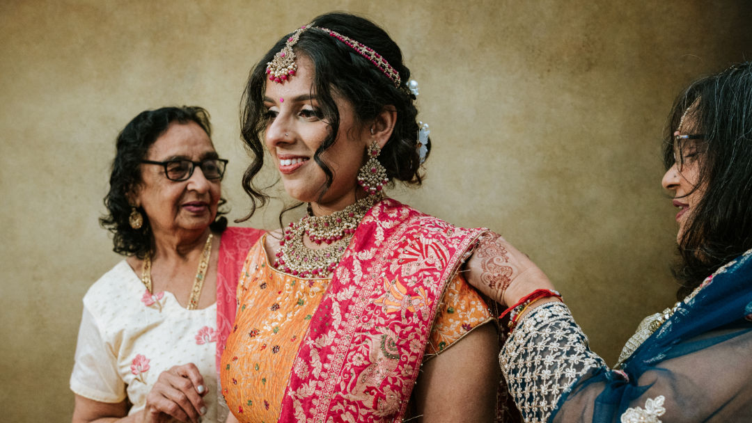 Sisters hold a groom's palla before the barrat in Coventry.