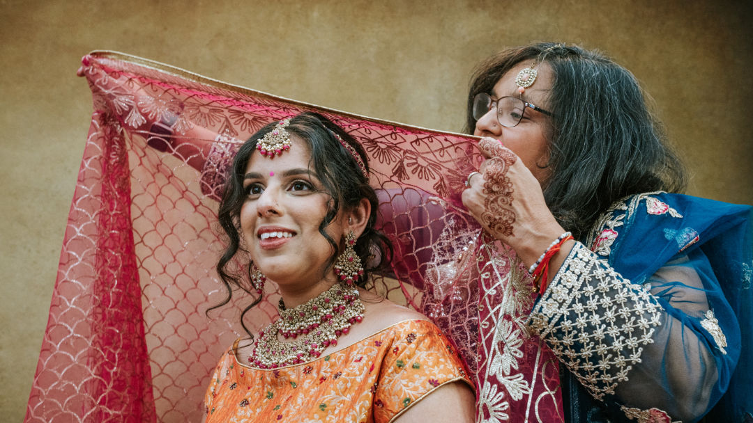 Sisters hold a groom's palla before the barrat in Coventry.