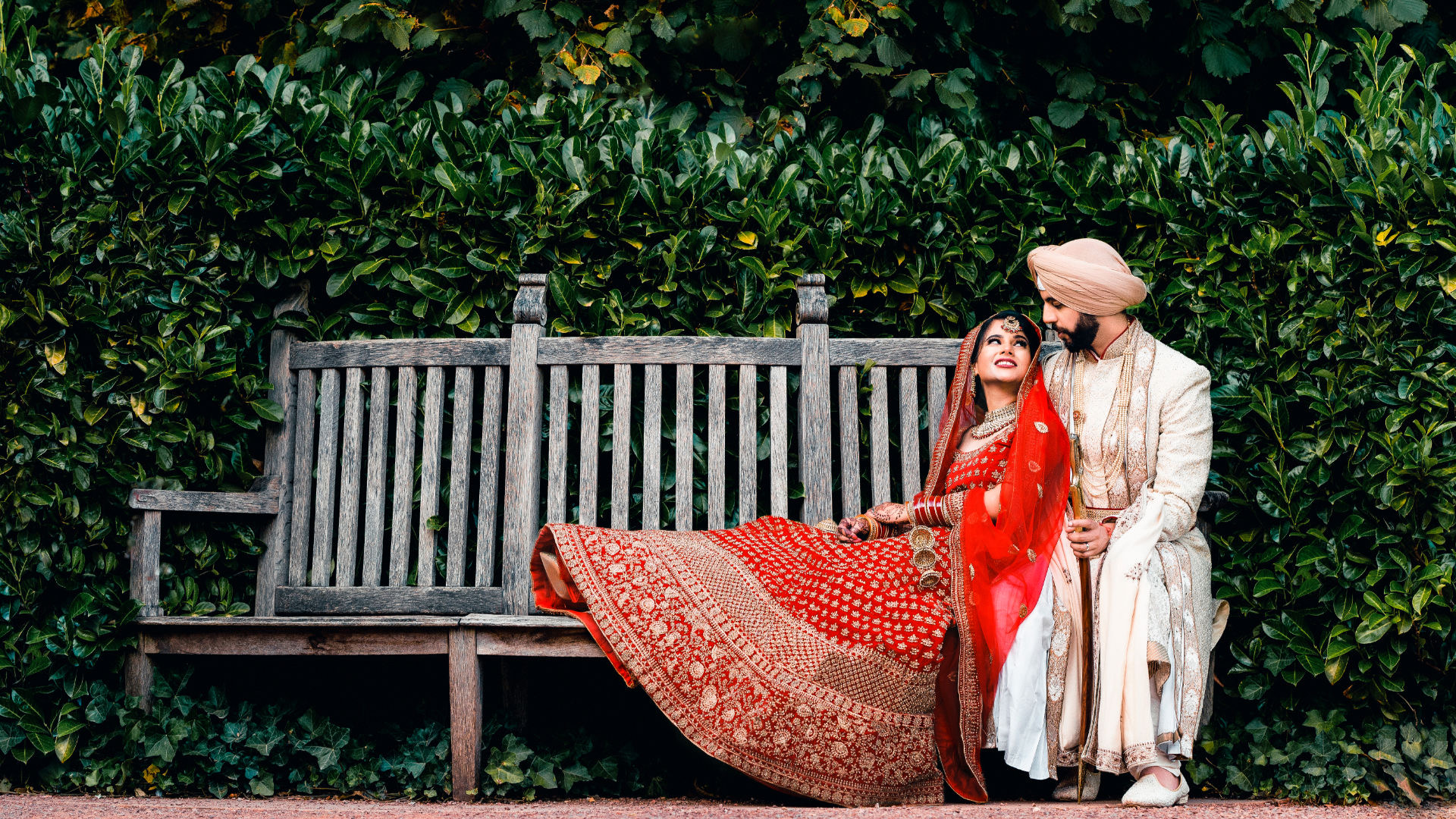 A person ties a cream colour Pagh or Turban on Sikh Groom's head at High Wycombe.